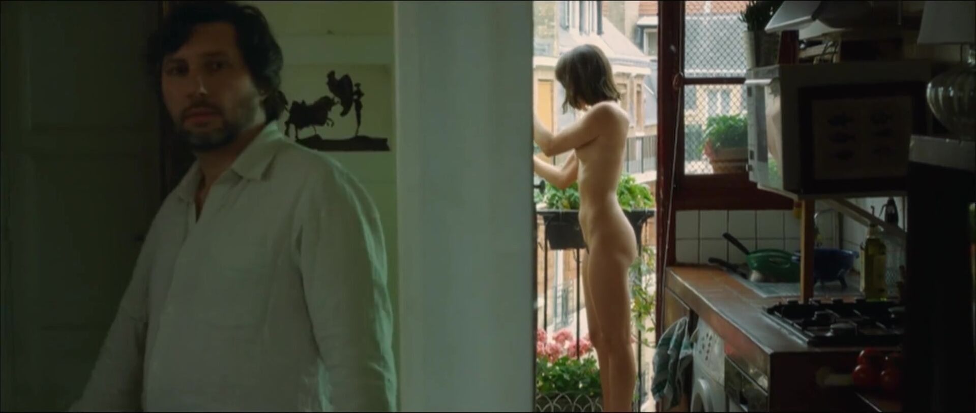 Gay Natural Lewd Vimala Pons is watched by man smoking on balcony in J'aurais Pu être Une Pute Anal